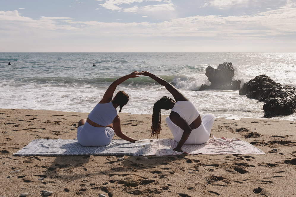 Women Meditating at the Beach
